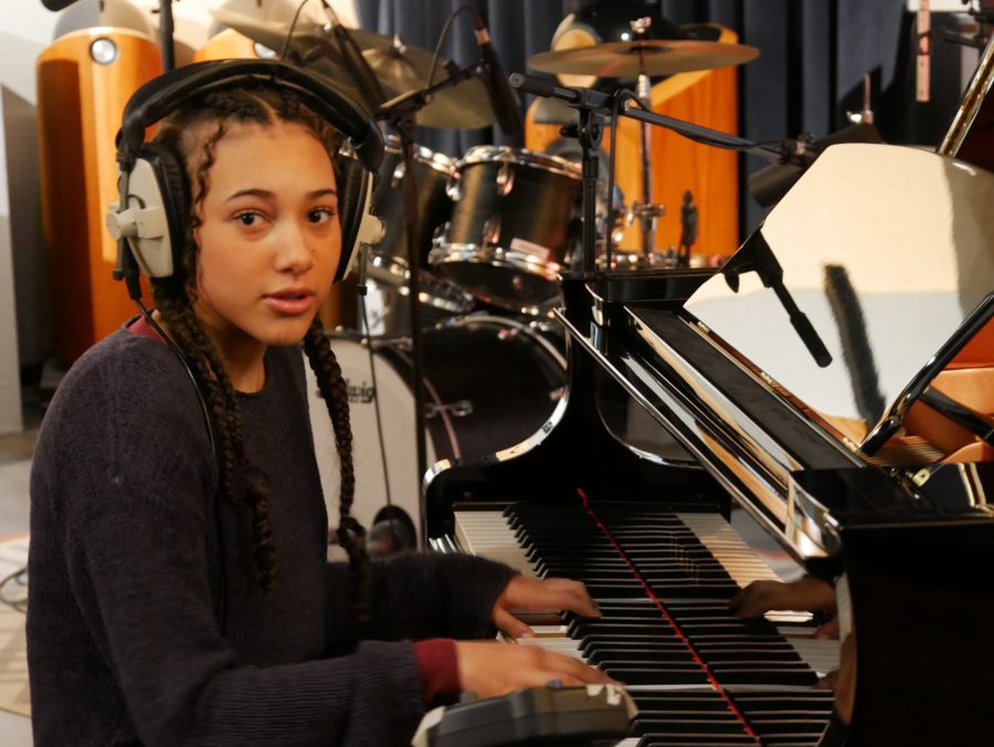 Nandi at the piano in headphones