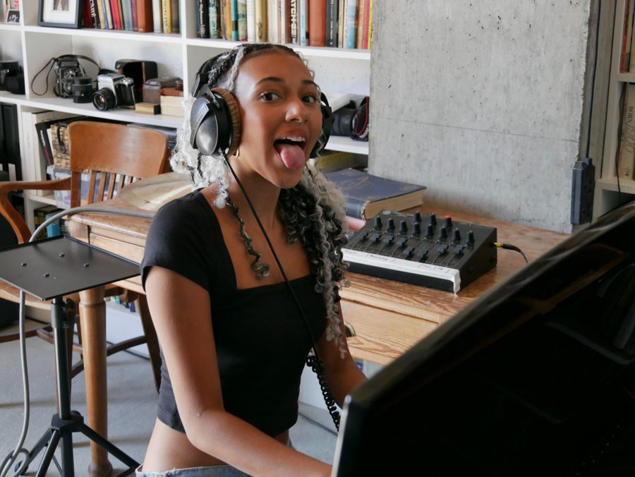 Nandi singing into a microphone